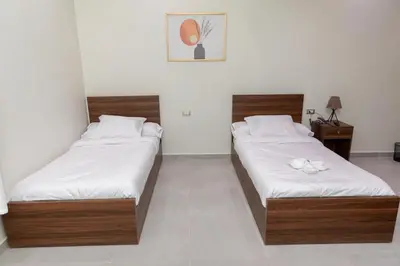 two beds sitting in a room with at Arkan Hotel Qena in Qena