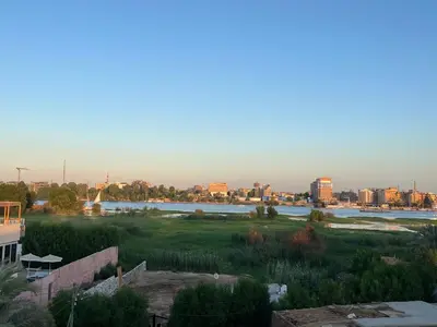 a view of a city with a river and buildings at The Nile Paradise in Al Aqālitah