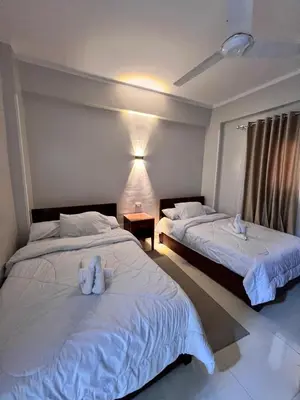 two beds in a hotel room with stuffed animals on them at The Nile Paradise in Al Aqālitah