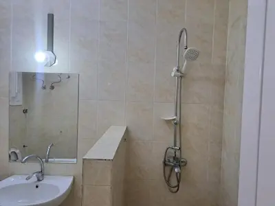 a bathroom with a shower with a sink and a toilet at Sweet Home 8 in Hurghada