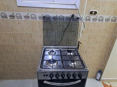 a stove top oven sitting in a kitchen at Sweet Home 8 in Hurghada