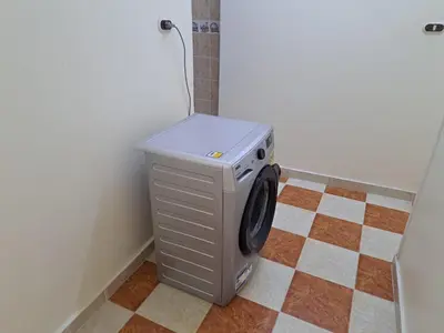 a washing machine in the corner of a room at Sweet Home 7 in Hurghada