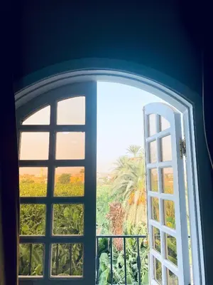 an open window with a view of a garden at Paradise House Holiday in Luxor
