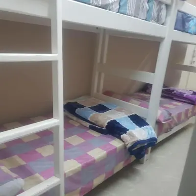 a bedroom with two bunk beds in a room at Sweet Home Hostel in Hurghada