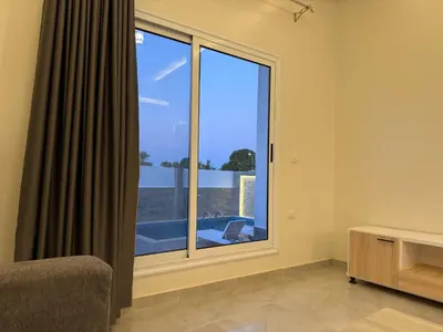 a room with a large window with a view at Nefertarie Villa in Luxor