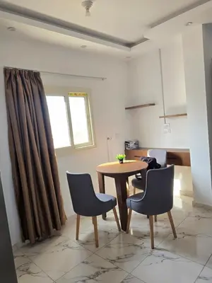 a dining room with a table and two chairs at الغردقة in Hurghada