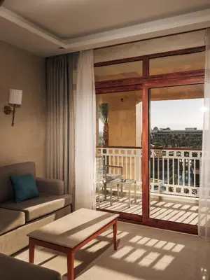 a living room with a couch and a balcony at Al Kasr Sahl Hasheesh - Ultra All-Inclusive in Hurghada
