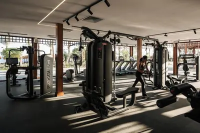 a woman walking through a gym with machines at Al Kasr Sahl Hasheesh - Ultra All-Inclusive in Hurghada