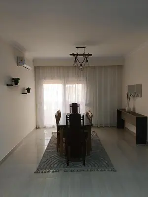 a dining room with a table and chairs in a room at Aldora residence شقه 3 غرف نوم و2 حمام in Hurghada