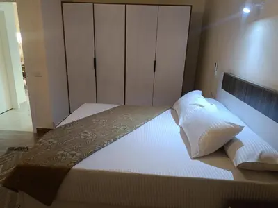 a bedroom with a large bed with white sheets and pillows at Aldora residence شقه 3 غرف نوم و2 حمام in Hurghada