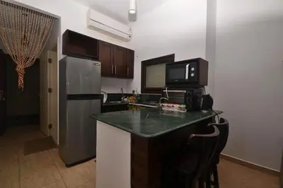 a kitchen with a counter top and a refrigerator at Turtles Beach Resort, Al Ahyaa in Hurghada
