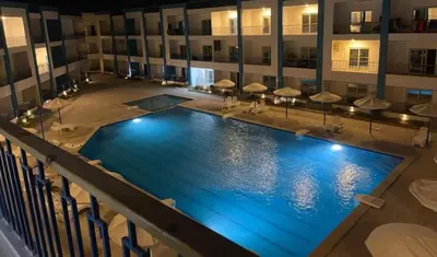 an overhead view of a large swimming pool in a hotel at Veronia gad chalet Mirage bay aqua park in Hurghada