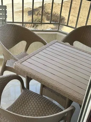 a wicker table and chair sitting on a balcony at La-Quinta Resort Erika in Hurghada