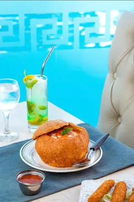 a table with a plate of food and a drink at One bedroom and reception in Hurghada