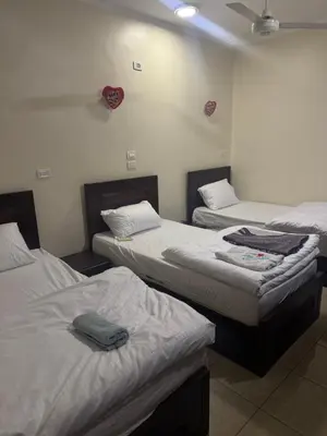 a room with three beds in a room at Safaga SeaView Rooftop in Safaga