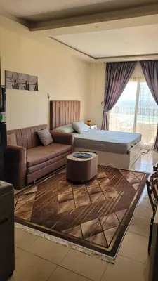 a living room with a bed and a couch at Casablanca star hurghada in Hurghada