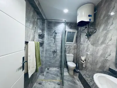 a bathroom with a shower and a toilet and a sink at One bedroom and reception Selena bay, Hurghada in Hurghada