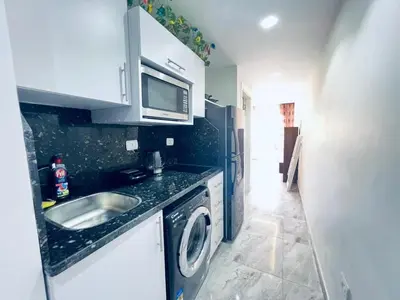 a kitchen with a sink and a washing machine at One bedroom and reception Selena bay, Hurghada in Hurghada
