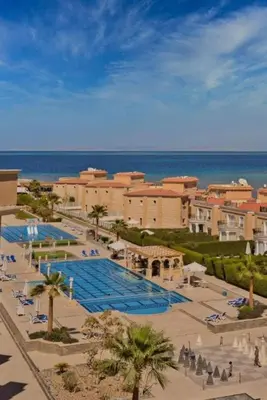 a resort with a large swimming pool next to the ocean at One bedroom and reception Selena bay, Hurghada in Hurghada