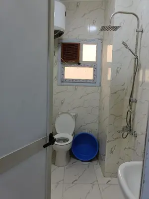 a bathroom with a toilet and a sink and a window at شقة كاملة بغرفتي نوم دور ارضي in Hurghada