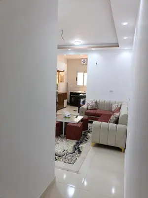 a living room with a couch and a table at شقة كاملة بغرفتي نوم in Hurghada