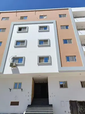 a large white building with stairs in front of it at شقة كاملة بغرفتي نوم in Hurghada