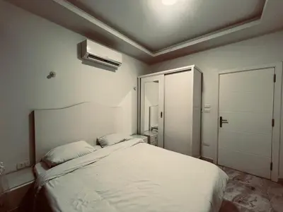a bedroom with a white bed and a door at Selena Bay in Hurghada