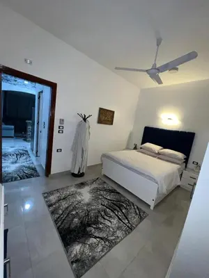 a bedroom with a bed and a ceiling fan at Al Mansi Luxury Retreat 1 in Luxor