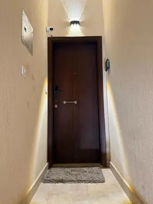 a brown door in a hallway with a light at 2BR G-Cribs in Hurghada