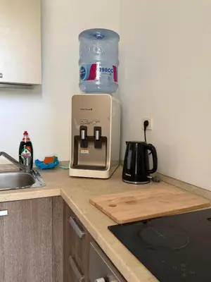 a kitchen counter with a jug of water on a toaster at 2BR G-Cribs in Hurghada