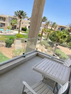 a balcony with a bench and a table and a view at 2BR G-Cribs in Hurghada