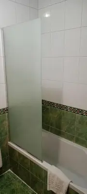 a bathroom with a shower and a tub with a mirror at S S Luxor Hotel in Luxor