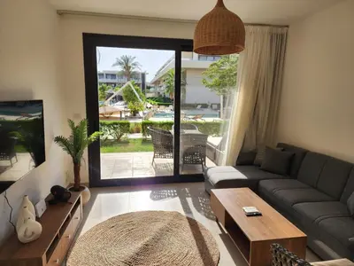 a living room with a couch and a table at El Gouna Poolfront Cozy Stay 2BR in Hurghada