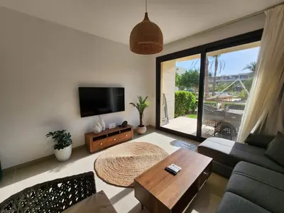 a living room with a couch and a table at El Gouna Poolfront Cozy Stay 2BR in Hurghada