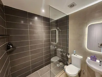 a bathroom with a toilet and a sink at El Gouna Poolfront Cozy Stay 2BR in Hurghada
