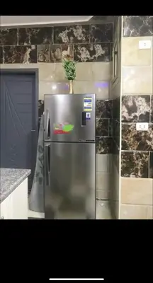 a refrigerator with a plant on top of it in a kitchen at Dream Apartment 4 in Hurghada