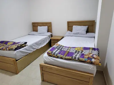 two beds sitting next to each other in a room at Apartmant for family in Hurghada in Hurghada