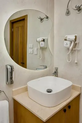 a bathroom with a white sink and a mirror at Diva Suites in Hurghada