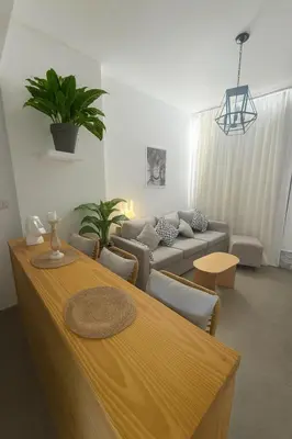 a living room with a table and a couch at Sunny Escape 1BR with Pool Access in Hurghada