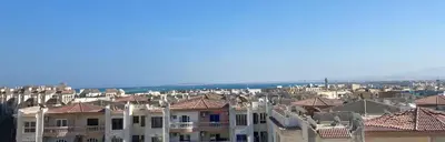a group of buildings with the ocean in the background at Jana in Hurghada