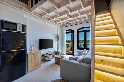 a living room with a couch and a television at Peaceful Oasis, Stunning Views and Refreshing Pool, El Gouna in Hurghada