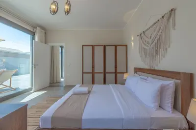 a bedroom with a large bed and a large window at Lovely 2BR with Private Pool in Bali El Gouna in Hurghada