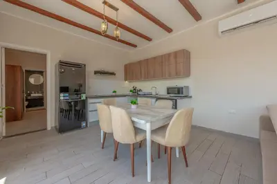 a kitchen and dining room with a table and chairs at Lovely 2BR with Private Pool in Bali El Gouna in Hurghada