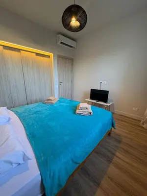 a bedroom with a large bed with a blue blanket at Fanadir Marina 3bedroom private pool in Hurghada
