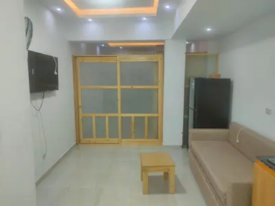 a living room with a couch and a tv at كمبوند كابتن in Hurghada