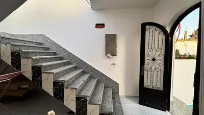 a stairway with a black door and a metal gate at Villa Hofni in Luxor