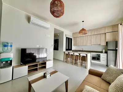 a living room with a couch and a table at Makadi Heights Luxury 1-BR App with Garden & Lagoon View in Hurghada