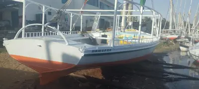 a boat sitting on the water in a harbor at دندرة بوت in Aswān