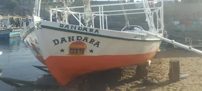 an orange and white boat sitting in the water at دندرة بوت in Aswān
