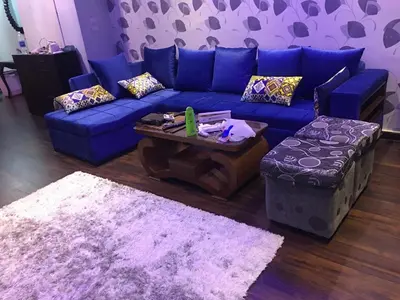 a living room with a blue couch and a table at The view in Hurghada
